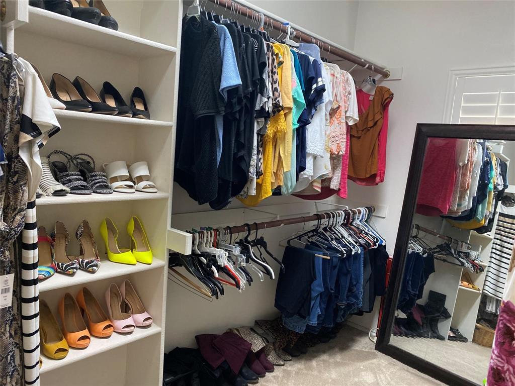 4025 Steepleridge Drive The Colony, TX 75056 - Photo 12 of 23 a view of walk in closet with clothes and shoes