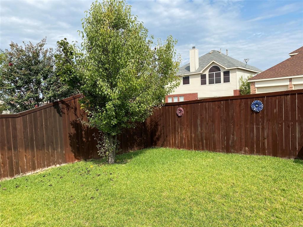4025 Steepleridge Drive The Colony, TX 75056 - Photo 21 of 23 a view of a white house in front of a yard with wooden fence