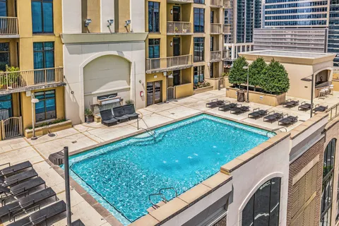 a view of a pool with chairs