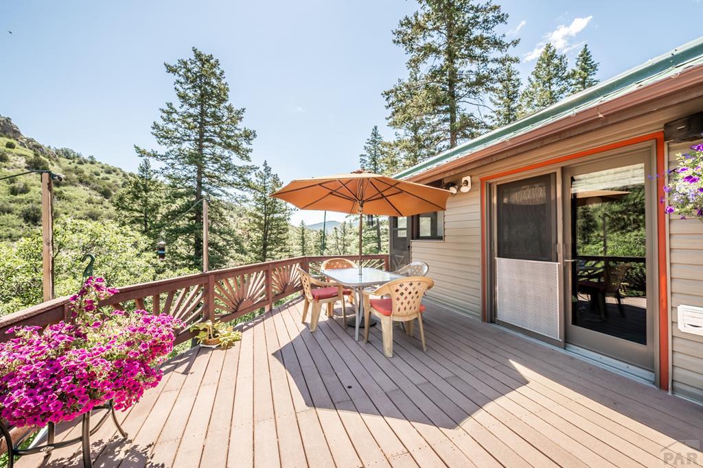 9600 Middle Creek Canyon Road Beulah, CO 81023 - Photo 1 of 50 a balcony with wooden floor table and chairs