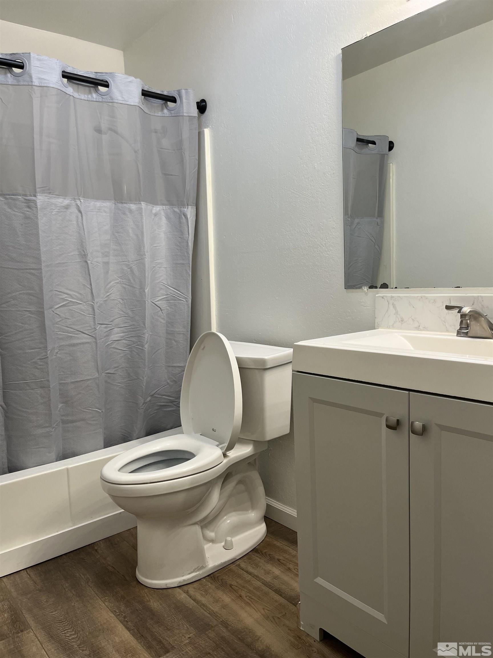 4600 Neil Road, Unit 44 Reno, NV 89502 - Photo 11 of 17 a white toilet sitting next to a bathroom sink