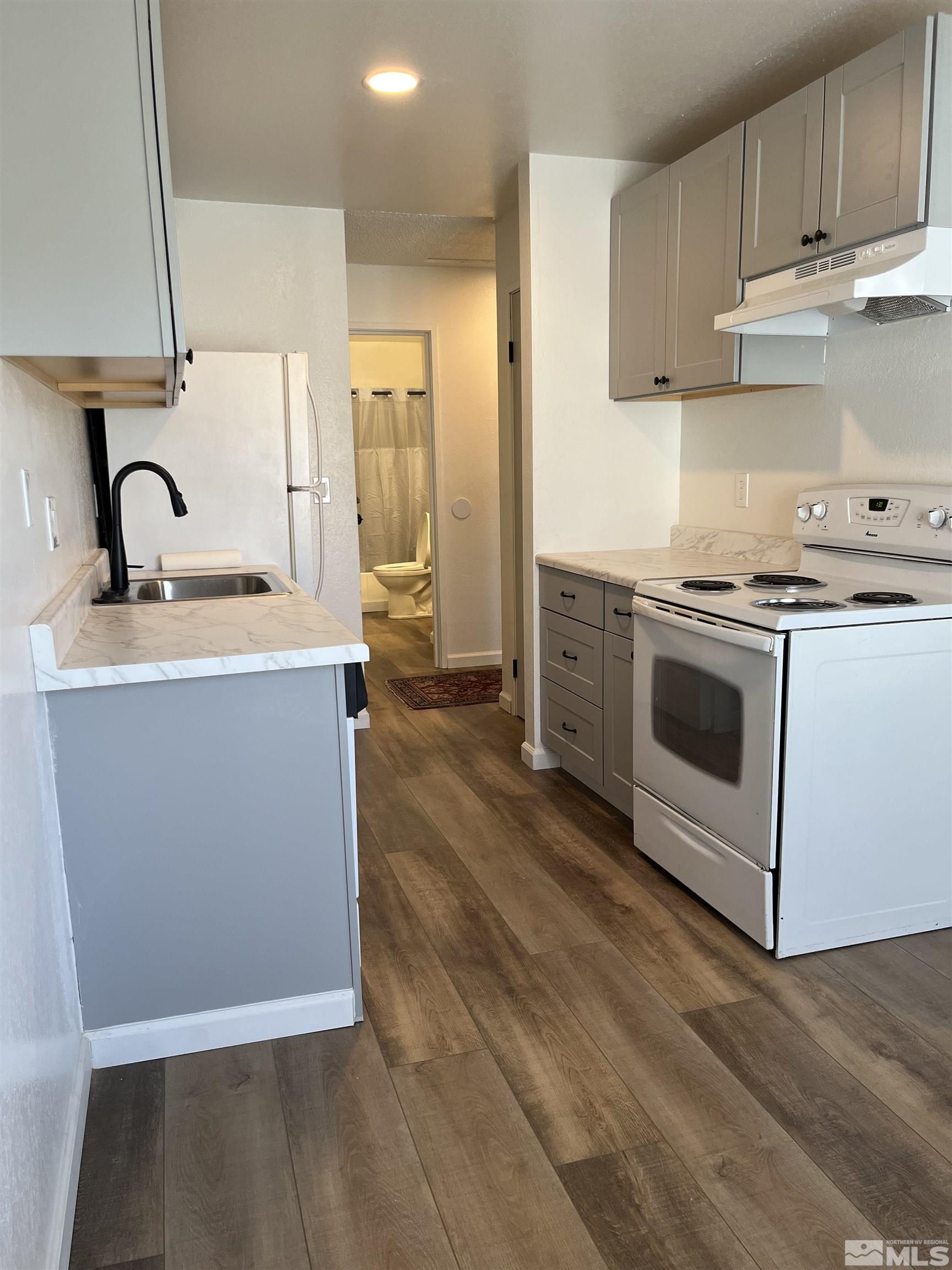 4600 Neil Road, Unit 44 Reno, NV 89502 - Photo 5 of 17 a kitchen with stainless steel appliances granite countertop a sink a stove and a refrigerator