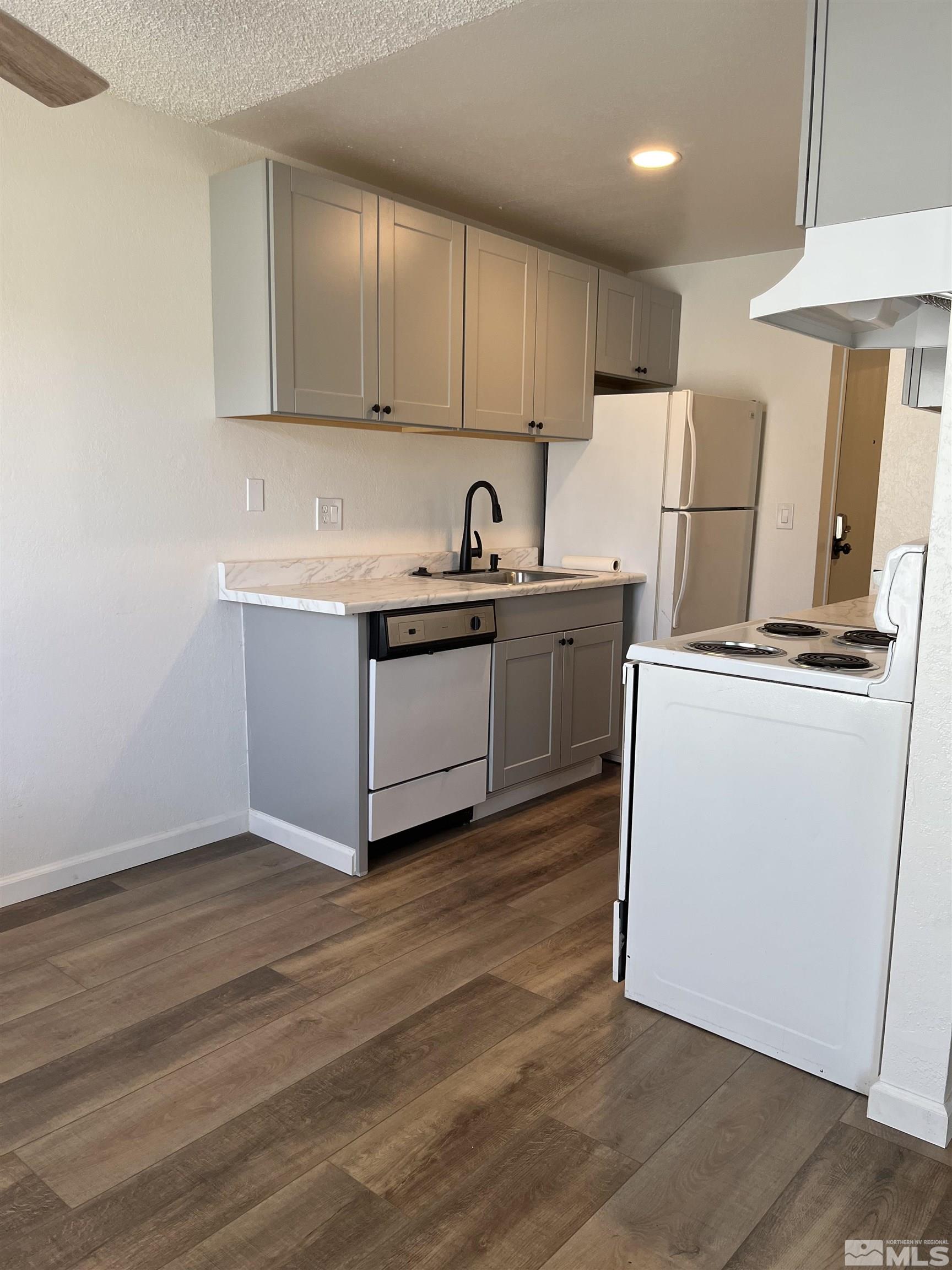 4600 Neil Road, Unit 44 Reno, NV 89502 - Photo 6 of 17 a kitchen with stainless steel appliances granite countertop a stove a sink and a refrigerator