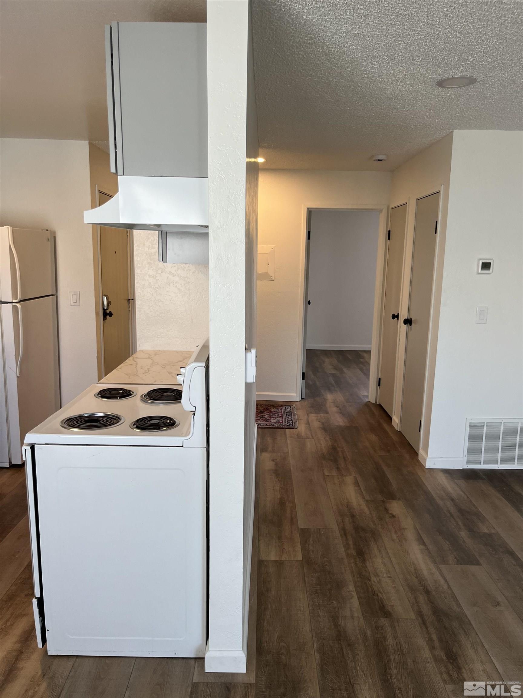 4600 Neil Road, Unit 44 Reno, NV 89502 - Photo 8 of 17 a kitchen that has a stove and a wooden floor