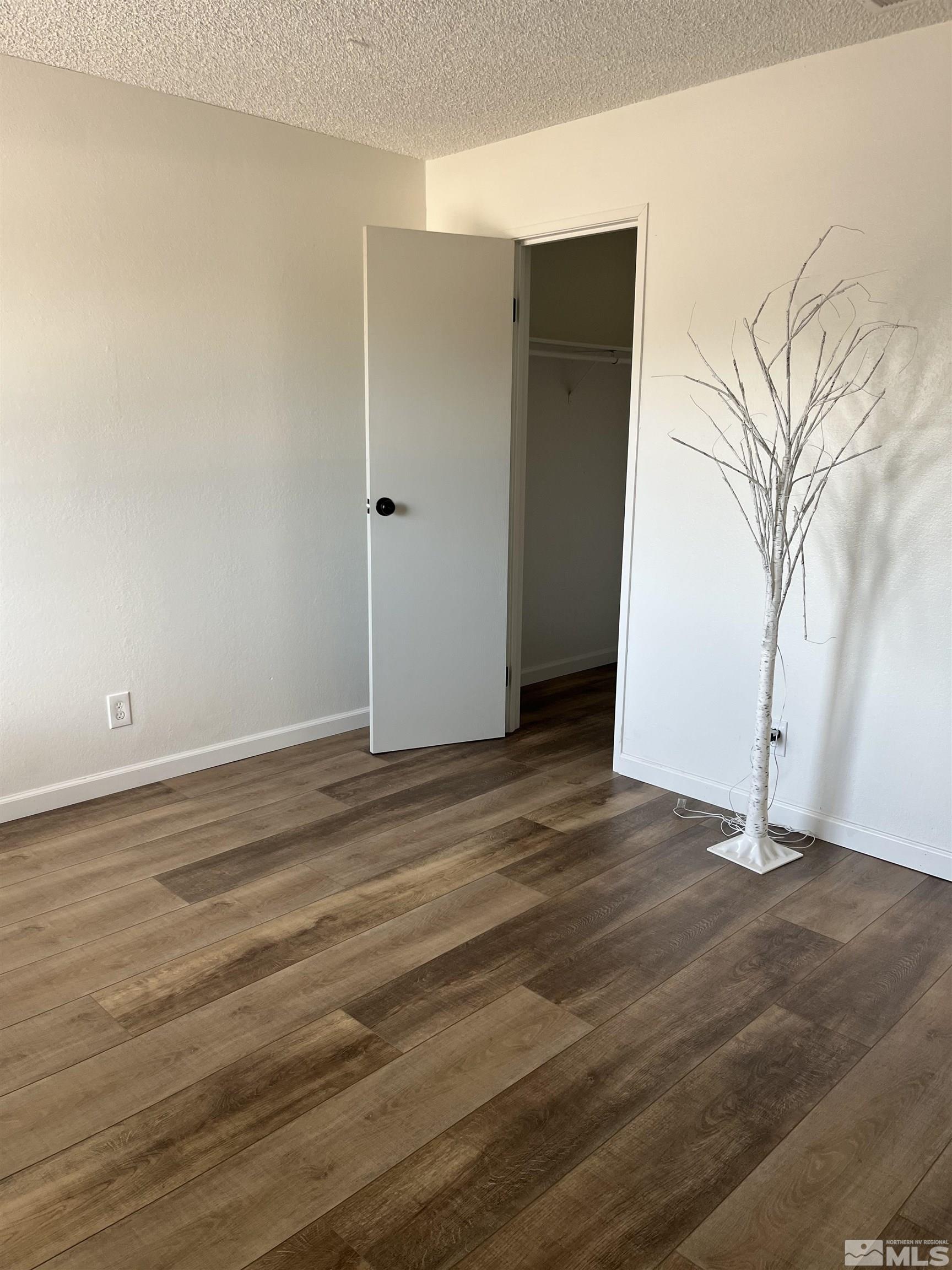 4600 Neil Road, Unit 44 Reno, NV 89502 - Photo 9 of 17 an empty room with wooden floor and windows