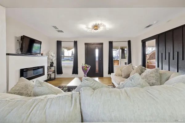 a living room with furniture fireplace and a flat screen tv