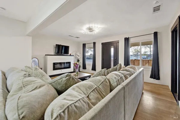a living room with furniture fireplace and a flat screen tv