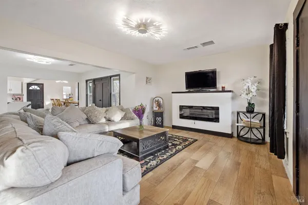 a living room with a bed and a large mirror