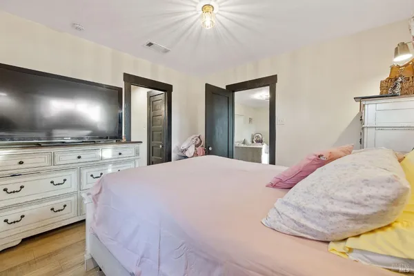 a bedroom with a bed and a dresser