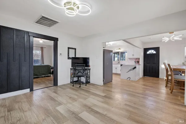 a living room with a bed furniture and a window