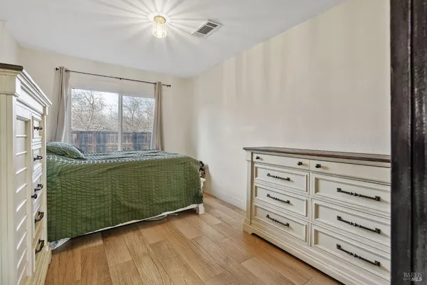 a dining hall with stainless steel appliances kitchen island granite countertop a table chairs and a refrigerator