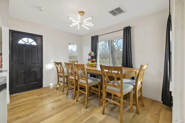 a kitchen with stainless steel appliances kitchen island granite countertop a refrigerator and a sink