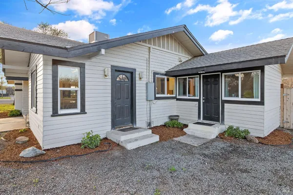 a view of a brick house with potted plants