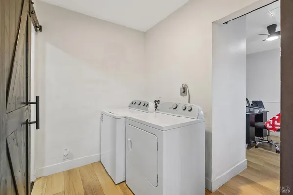 a large kitchen with a lot of counter space and stainless steel appliances