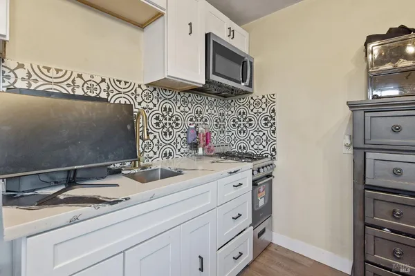 a backyard of a house with table and chairs