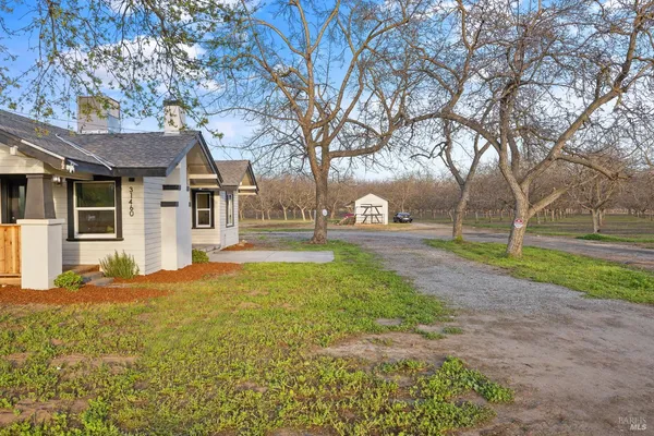 a house with huge green field in front of it