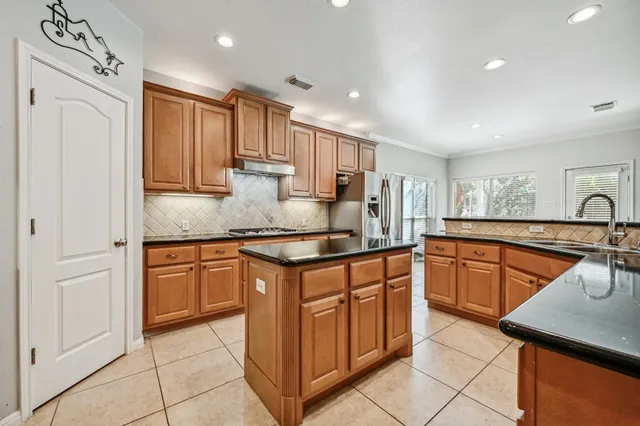 a kitchen with stainless steel appliances granite countertop a sink and cabinets