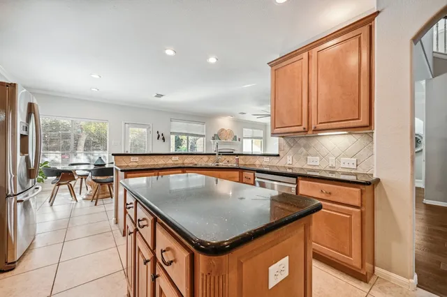 a kitchen with stainless steel appliances granite countertop a sink a counter top space and cabinets