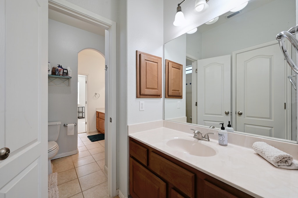 12304 Aralia Ridge Drive Austin, TX 78739 - Photo 30 of 37 a bathroom with a sink a toilet and shower