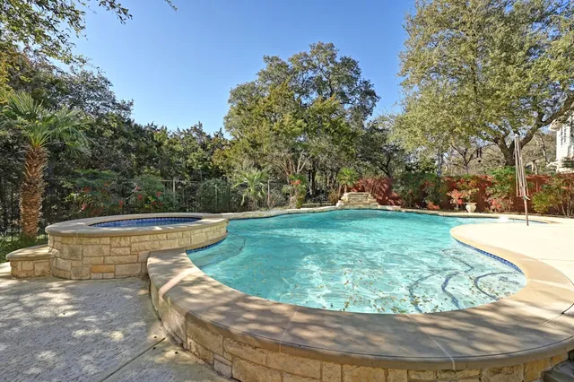 a view of a swimming pool with a yard