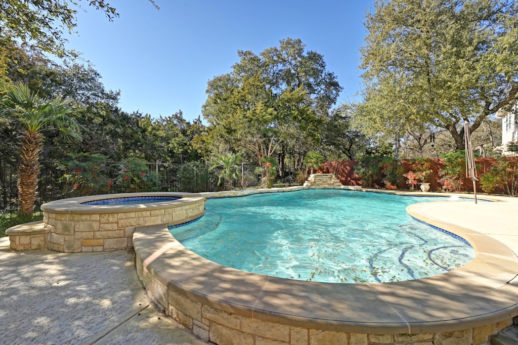 12304 Aralia Ridge Drive Austin, TX 78739 - Photo 34 of 37 a view of a swimming pool with a yard