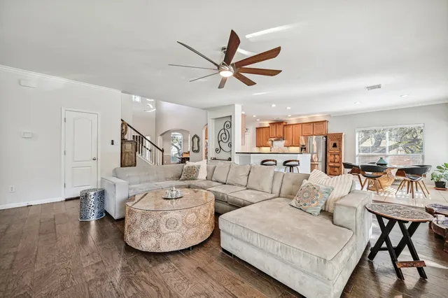 a living room with furniture and a wooden floor