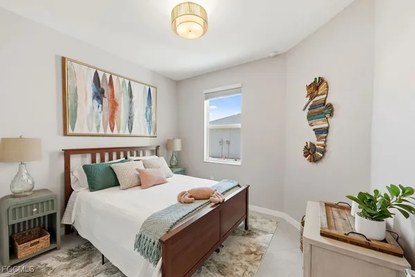 a bedroom with bed and a window