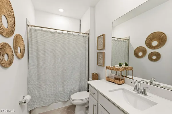 a bathroom with a sink mirror vanity and toilet