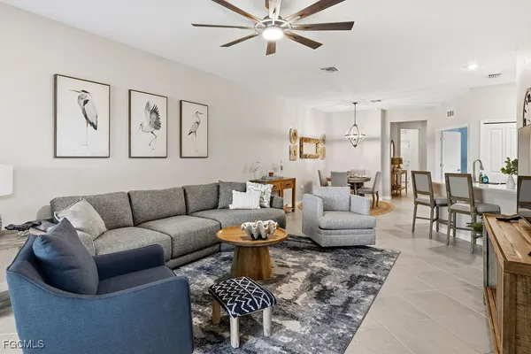a living room with furniture a rug and a chandelier