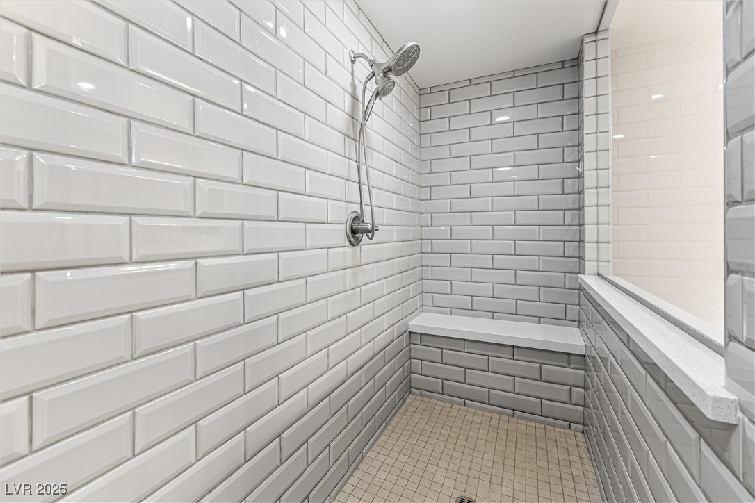 4631 Amazing View Street Las Vegas, NV 89129 - Photo 34 of 94 Full bath with tiled shower, tile walls, and tile patterned flooring