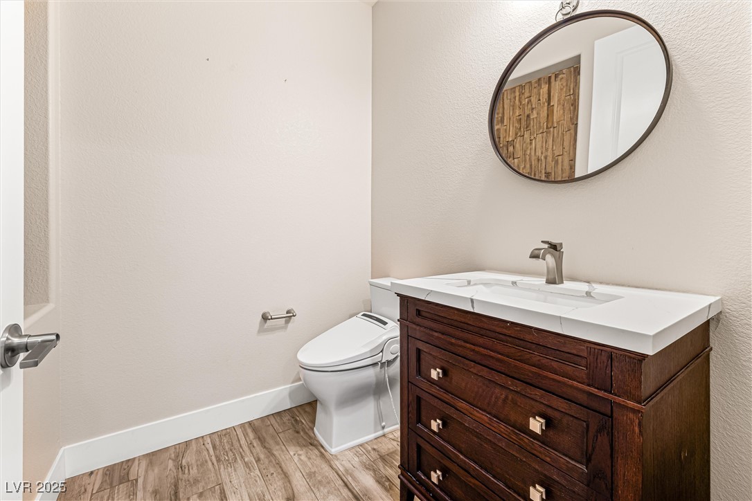 4631 Amazing View Street Las Vegas, NV 89129 - Photo 41 of 94 Bathroom featuring light wood-style floors, a textured wall, and vanity