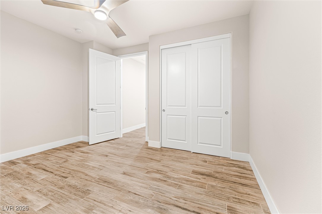 4631 Amazing View Street Las Vegas, NV 89129 - Photo 44 of 94 Unfurnished bedroom with light wood-style flooring, ceiling fan, and a closet
