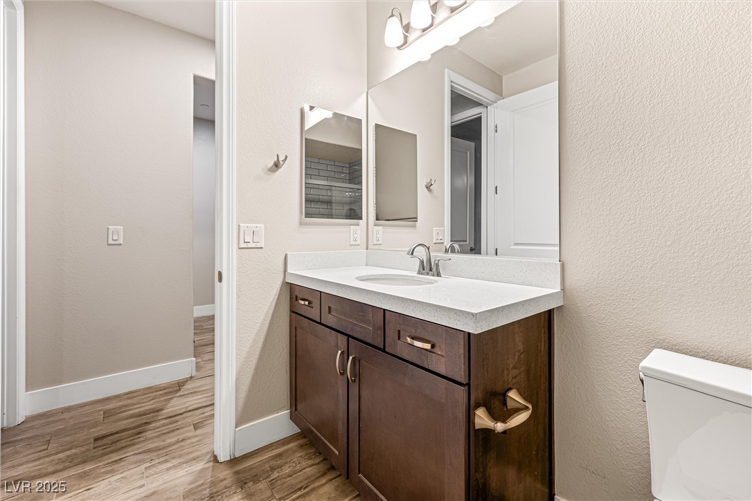 4631 Amazing View Street Las Vegas, NV 89129 - Photo 51 of 94 Bathroom with vanity, a textured wall, and light wood-style flooring