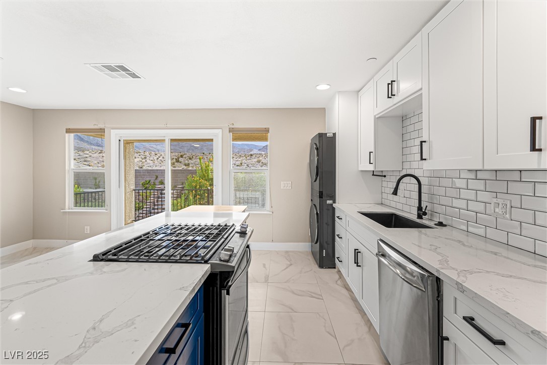 4631 Amazing View Street Las Vegas, NV 89129 - Photo 63 of 94 Kitchen featuring white cabinets, light stone countertops, stainless steel appliances, and recessed lighting
