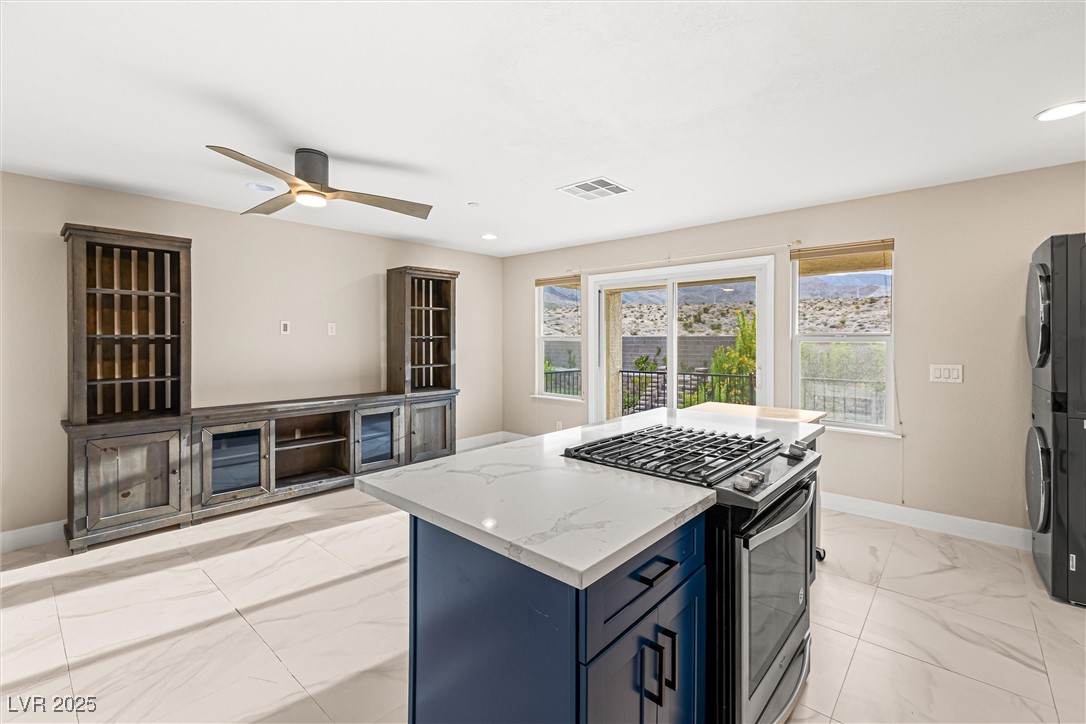 4631 Amazing View Street Las Vegas, NV 89129 - Photo 64 of 94 Kitchen with gas stove, blue cabinets, light stone counters, light marble finish floors, and recessed lighting