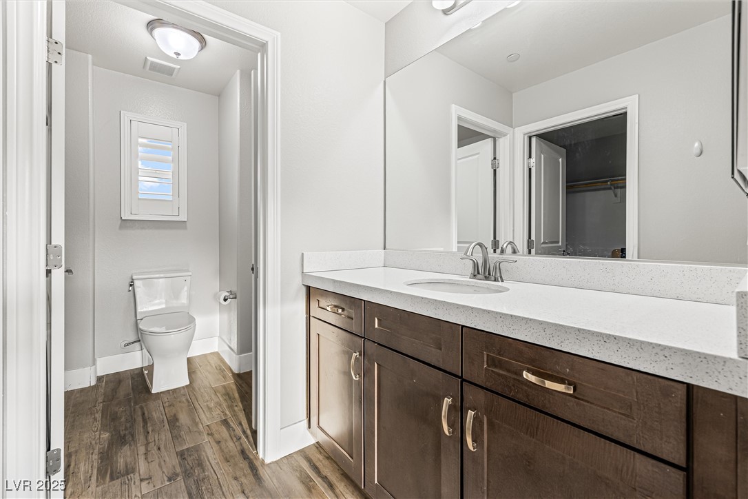 4631 Amazing View Street Las Vegas, NV 89129 - Photo 73 of 94 Full bathroom with dark wood finished floors, vanity, and a walk in closet