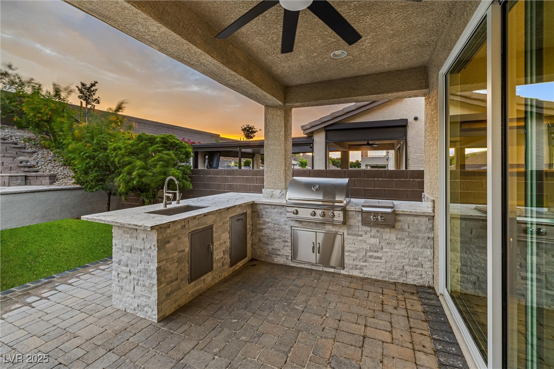 4631 Amazing View Street Las Vegas, NV 89129 - Photo 84 of 94 Patio terrace at dusk featuring a patio, a ceiling fan, and area for grilling