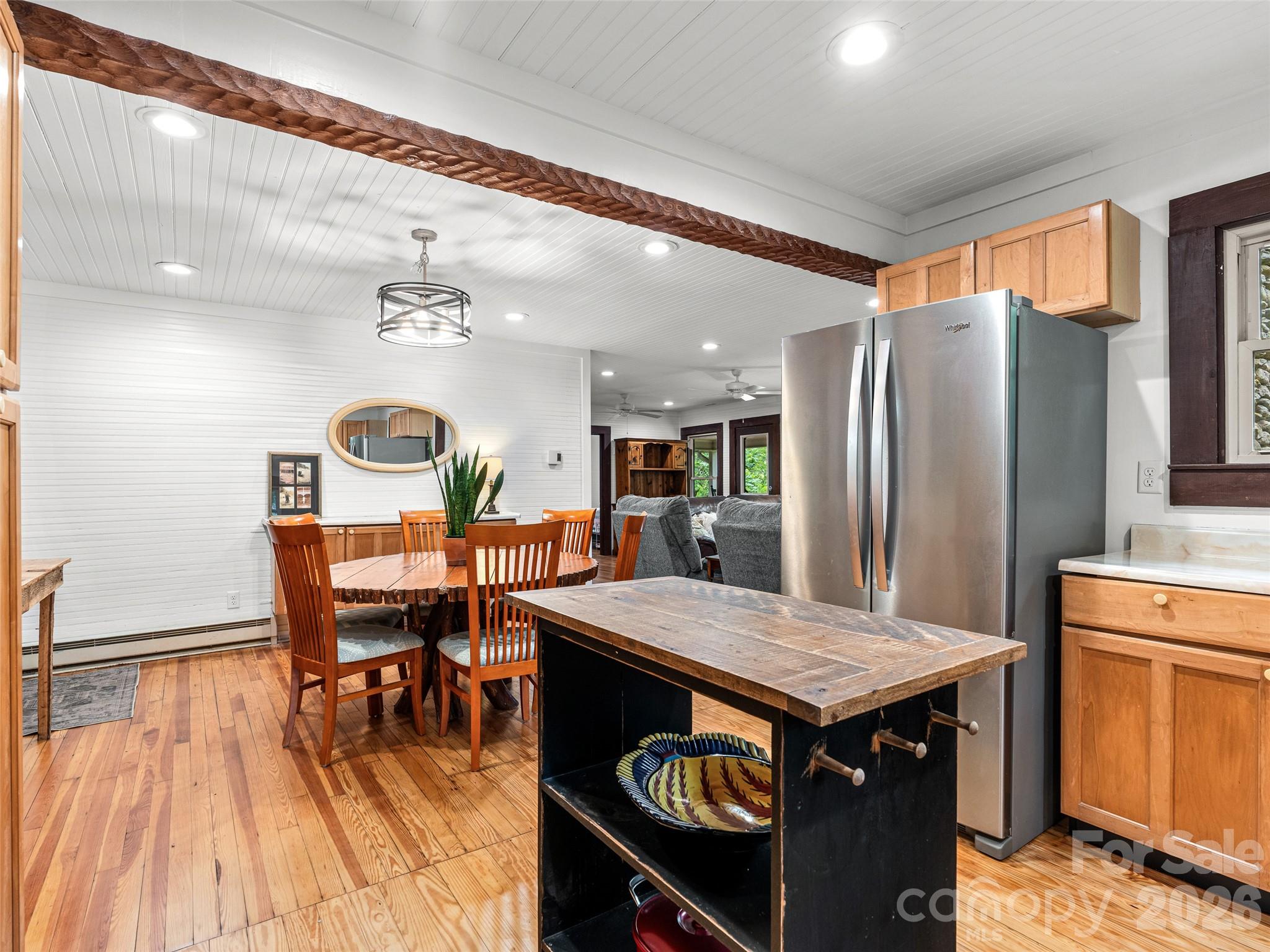 206 Chestnut Hill Road Gerton, NC 28735 - Photo 10 of 48 a kitchen with stainless steel appliances granite countertop a table chairs and a refrigerator