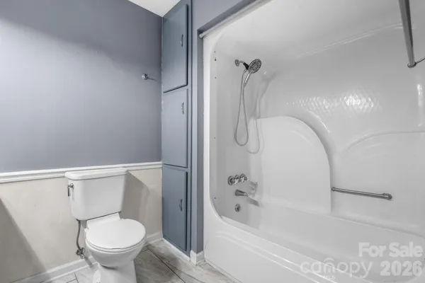 a bathroom with a toilet and a bathtub