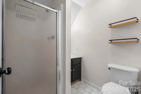 a bathroom with a toilet and a shower