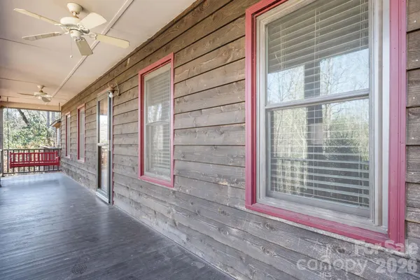 a view of a room with wooden floor and windows