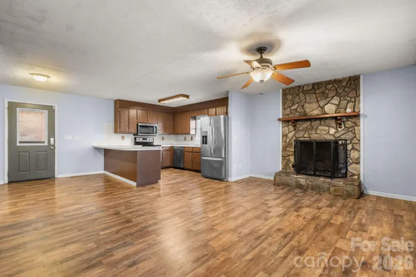 a view of a kitchen with a sink and a fireplace