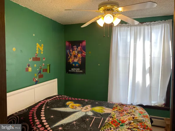 a bedroom with a bed and a painting on the wall