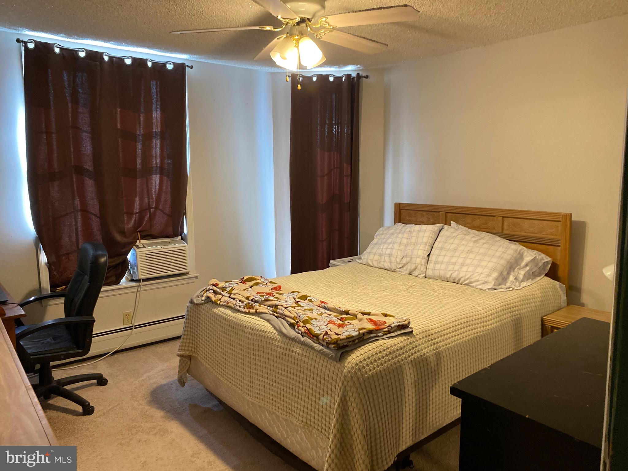 1026 Scott Street Kulpmont, PA 17834 - Photo 17 of 32 a bedroom with a bed and a chandelier