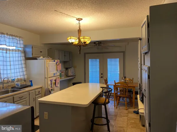a kitchen with refrigerator and dining table