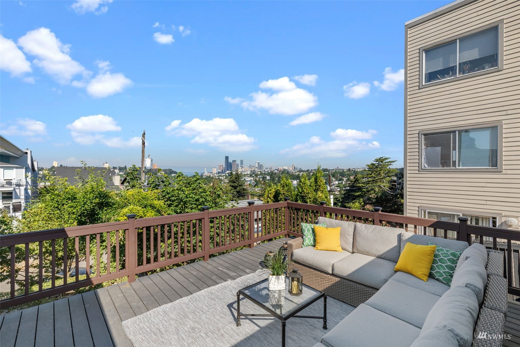 1542 30th Avenue South Seattle, WA 98144 - Photo 2 of 39 a balcony with wooden floor and outdoor seating