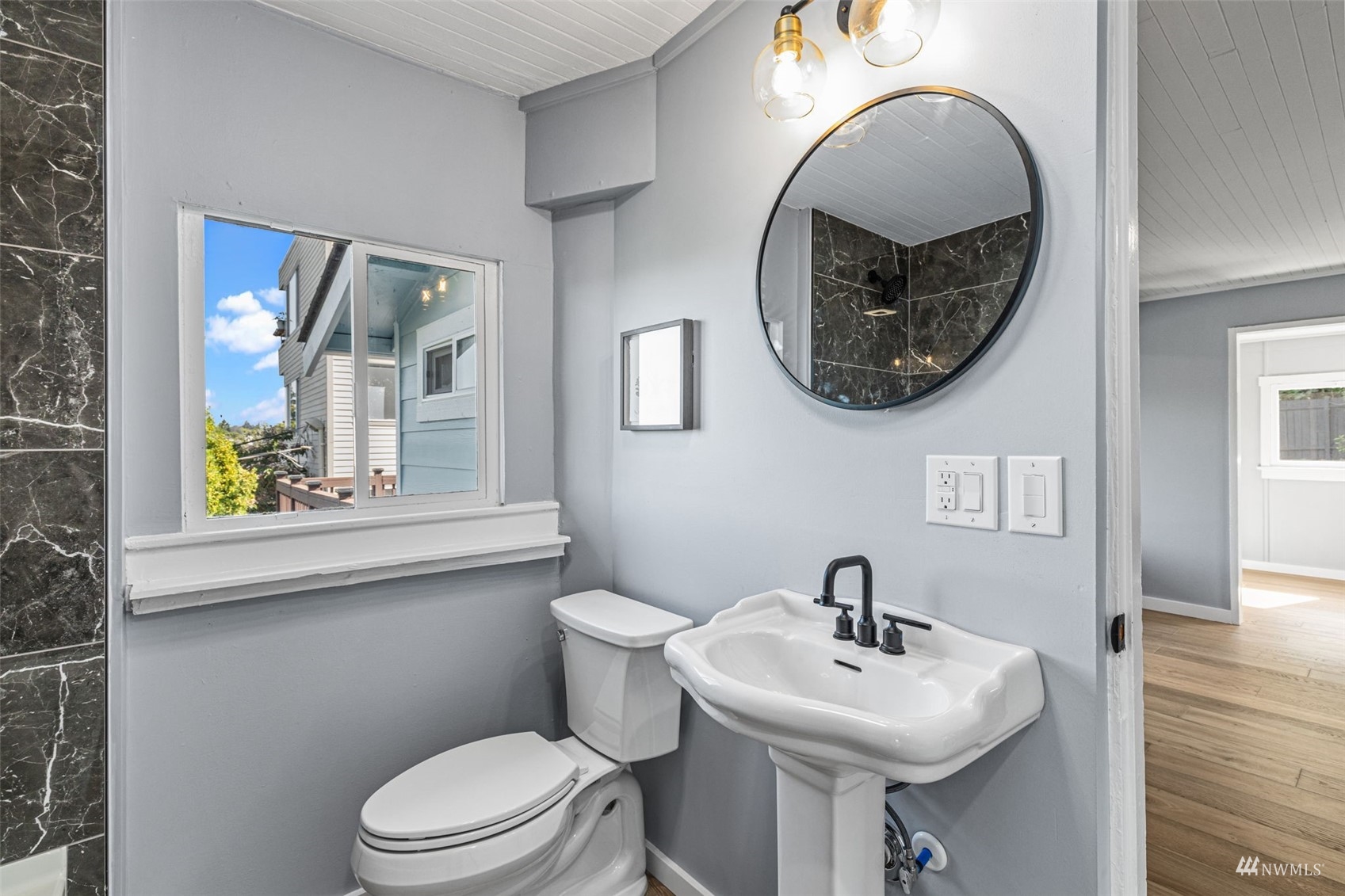 1542 30th Avenue South Seattle, WA 98144 - Photo 27 of 39 a bathroom with a sink a mirror and a toilet