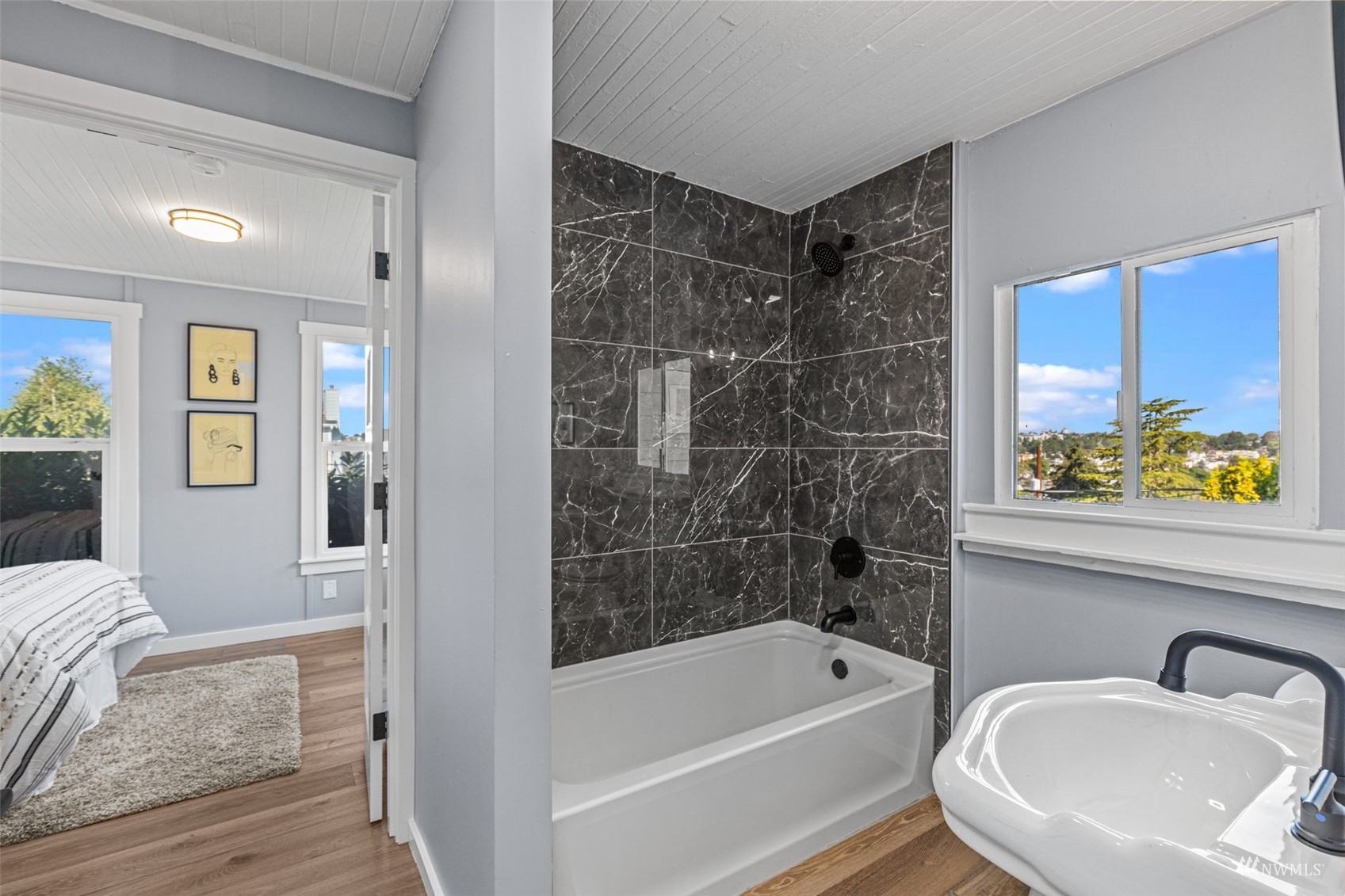 1542 30th Avenue South Seattle, WA 98144 - Photo 28 of 39 a bathroom with a bathtub a sink a window and a shower