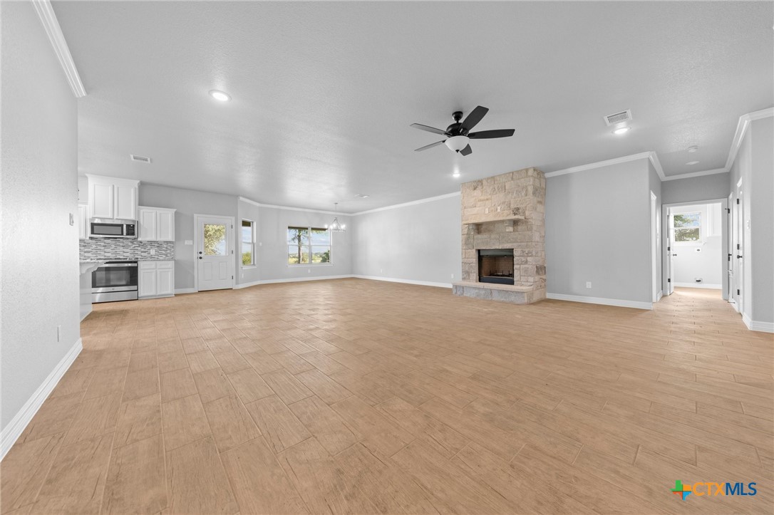 3030 Millhouse Road Copperas Cove, TX 76522 - Photo 17 of 24 an empty room with chandelier fan and windows