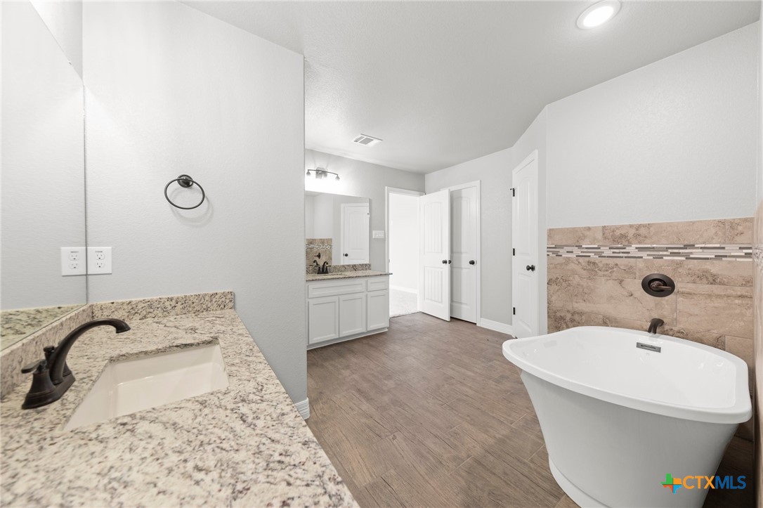 3030 Millhouse Road Copperas Cove, TX 76522 - Photo 18 of 24 a bathroom with a sink and a mirror